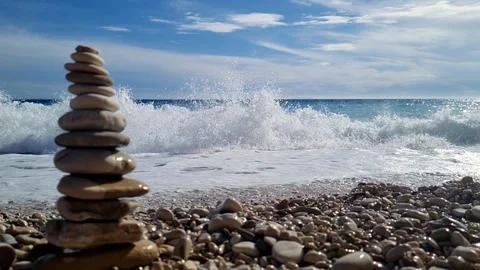 Pebble tower Splashing wave  Slow Stock Footage 305844001