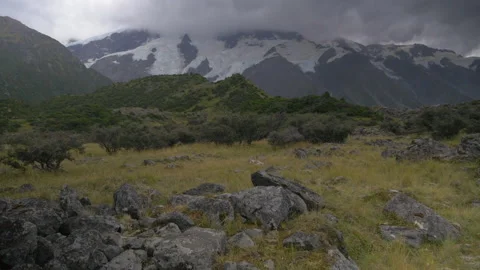 A pebbled meadow surrounded by mountains, in New Zealand Stock Footage 215390919