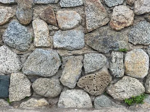 Pebbled stone wall texture Stock Photos