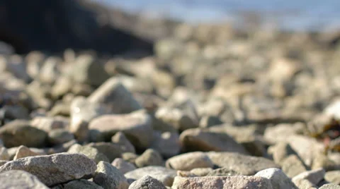 Pebbles and Ocean Rack Focus Stock Footage 28397569