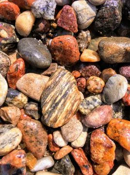 Pebbles and stones in the ocean. Stock Photos