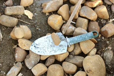 Pebbles and trowel Stock Photos
