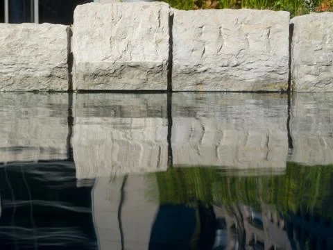Pebbles in an artificial pond Stock Photos