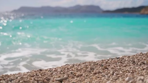 Pebbles on the background of an azure sea wave. Pebble beach. Beach in Kas Stock Footage 169663567
