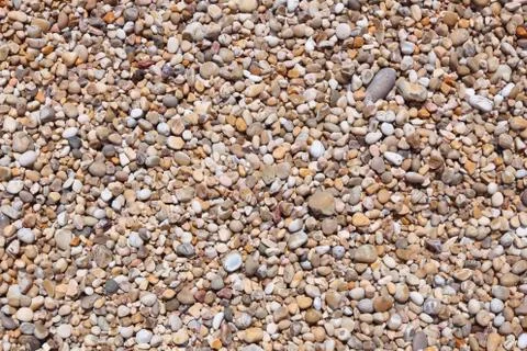 Pebbles background - shingle beach pattern in Gargano Peninsula, Italy. Stock Photos