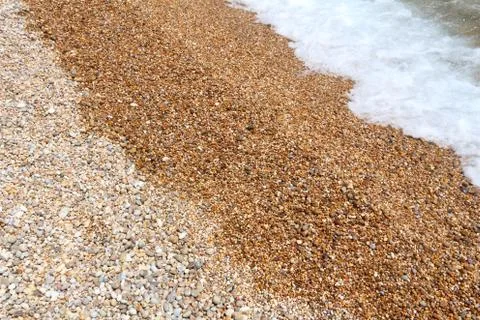 Pebbles background - shingle beach pattern in Gargano Peninsula, Italy. Stock Photos