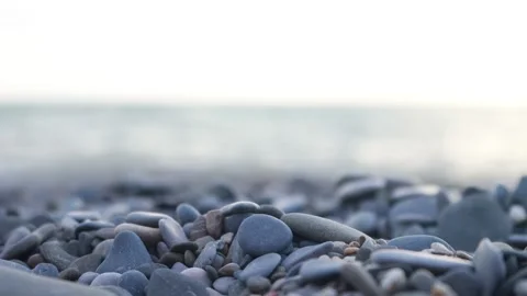 Pebbles on the beach with sea waves on the background Video stock 137154510