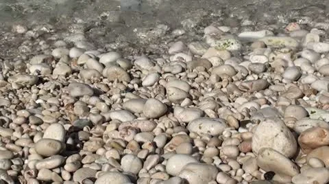 Pebbles on the beach washed by the sea Stock Footage 10447776