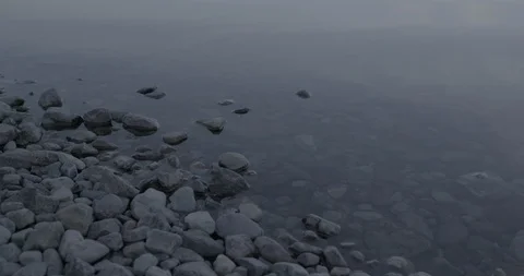 Pebbles on the coast of lake Video stock 104199078