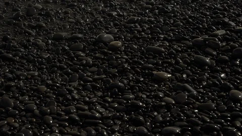 Pebbles by the Coastline with Waves Rushing In Stock Footage 115840127