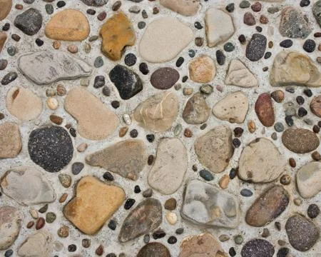 Pebbles in Concrete Stock-Fotos