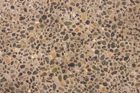 Pebbles in concrete. Stock Photos