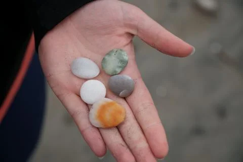 Pebbles in hand Stock Photos