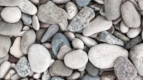 Pebbles, large oval beach sea stones, top view, rotating, turning, close-up.. 스톡 동영상 256325408
