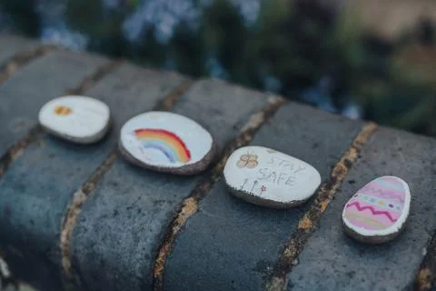 Pebbles painted with rainbow, Easter egg, stay safe and thank you NHS message Stock Photos