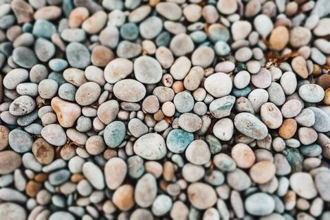 Pebbles pattern. Small grey, yellow stones, pebble on sea, ocean coast. Stone Stock Photos