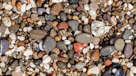 Pebbles polished wet on the beach, rotating, turning 스톡 동영상 249585437