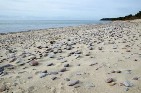 Pebbles at a sandy beach Stock Photos