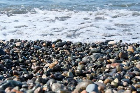 Pebbles on the seashore as an abstract background. Foto stock