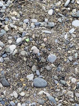 Pebbles on the seashore, background Stock Photos