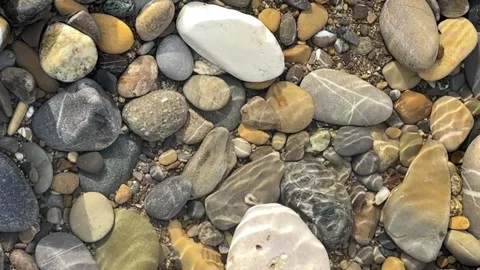 Pebbles in shallow water Stock Footage 276013243