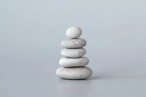 Pebbles stack on grey background, zen balance meditation minimal concept P... Stock Photos