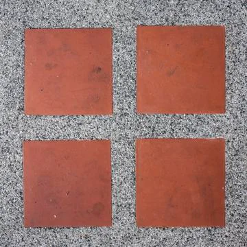 Pebbles stone road texture background with square orange tile Stock Photos