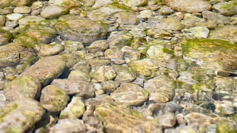 Pebbles under clear water. Transparent river. Stream in mountain. Stock Footage 234093292