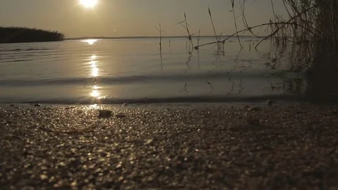 Pebbles, waves on the beach at sunset Stock Footage 74833592