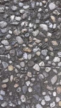 Pebbly pattern background, pebbles embedded in concrete. Stock Photos