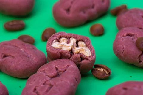 Pecan on a green background background. Close-up of pecans in a shell as a pa Stock Photos
