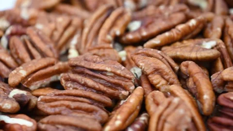 Pecan halves piled on wooden table surface close up kitchen Stock Footage 331585111
