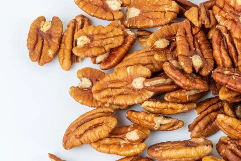 Pecan halves on a white background. Nuts. Stock Photos
