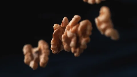 Pecan nuts and roasted corns falling. Slow Motion. Stock Footage 89604455