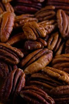 Pecan nuts background vertical close-up hd. Texture of pecan Stock Photos