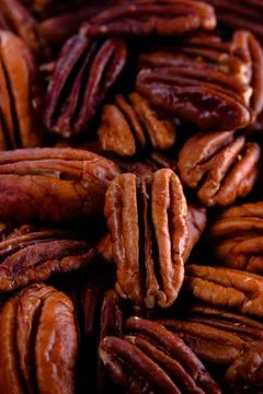 Pecan nuts background vertical close-up hd. Pecans texture Stock Photos