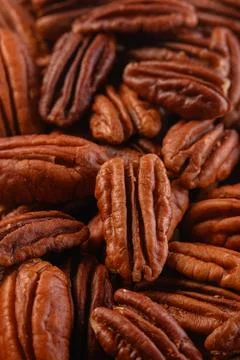 Pecan nuts background vertical close-up hd. Roasted nuts Stock Photos