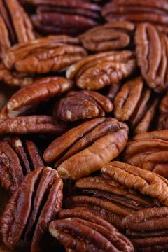 Pecan nuts background vertical close-up hd. Roasted nuts Stock Photos