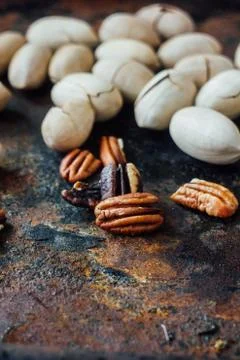 Pecan nuts on black rustic board. Stock Photos