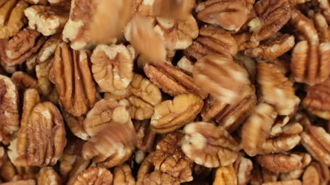 Pecan nuts falling down in bowl, top view. Healthy food concept Stock Footage 277478964
