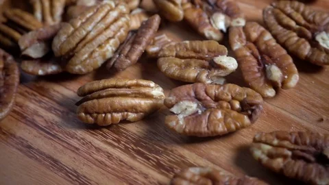 Pecan nuts falling onto kitchen table in slow motion Stock Footage 76437680
