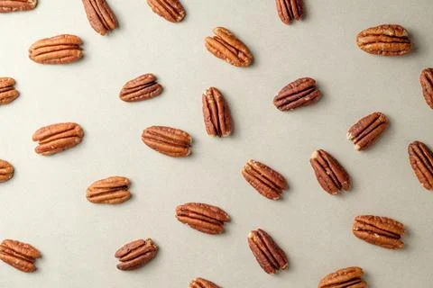 Pecan nuts scattered on a rustic textured background in natural light Stock Photos