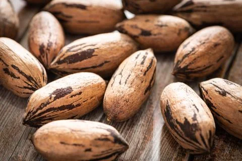 Pecan Nuts In Shell On Wood Table Stock Photos