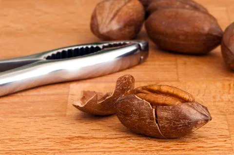 Pecans and nutcracker Stock Photos