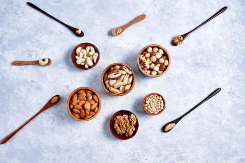Pecans, hazelnuts, almonds, pine nuts, Brazil nut, cashews in wooden bowls on Stock Photos