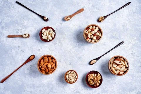 Pecans, hazelnuts, almonds, pine nuts, Brazil nut, cashews in wooden bowls on Stock Photos
