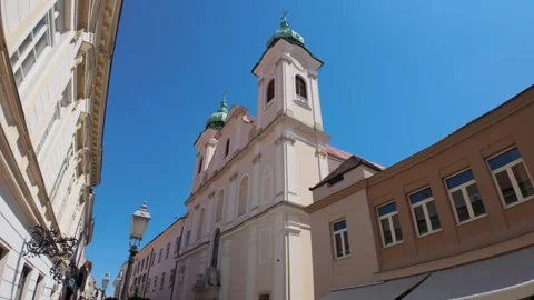 Pecs, Hungary  May 1, 2026: Low angle view of Saint Augustine's Church facad.. Video stock 336518845