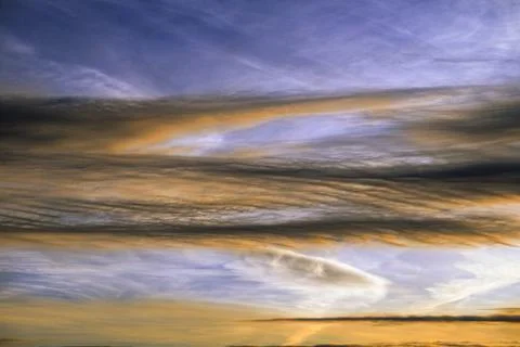 Peculiar cloud formations Tinted by the Setting Sun Stock Photos