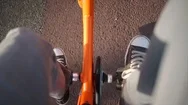 Pedals On An Orange Bike In Sneakers Top View Stock Footage