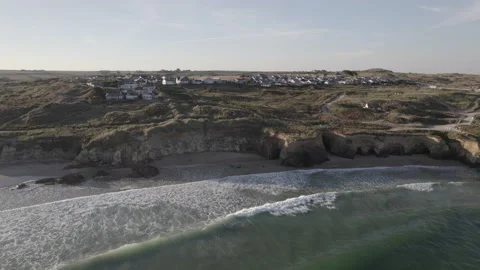 Pedestal down over Atlantic ocean looking back at Cornish coast Video stock 204789142